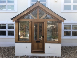 Enclosed oak porch with double glazed units and a slate roof
