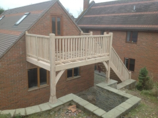 Oak balcony on brick garage