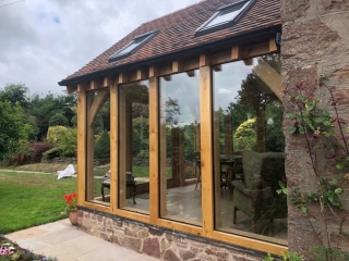 Oak conservatory with glass floor to ceiling