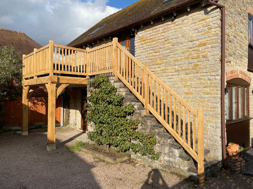 Oak Framed balcony with oak balustrade fitted to a stone barn
