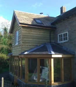 Oak framed extension with two storey middle bay