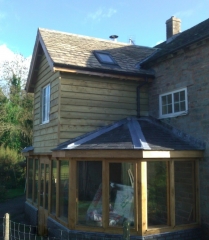 Oak framed extension with softwood clad