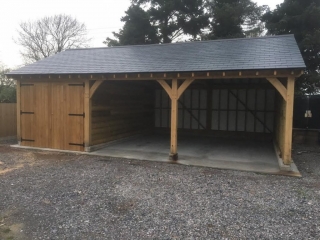Triple bay oak garage with one bay enclosed