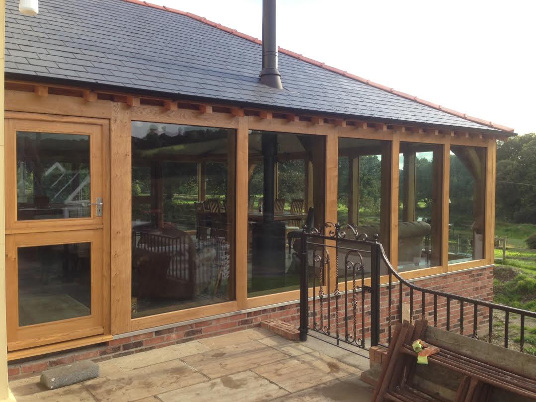 Large oak framed extension with hipped roof