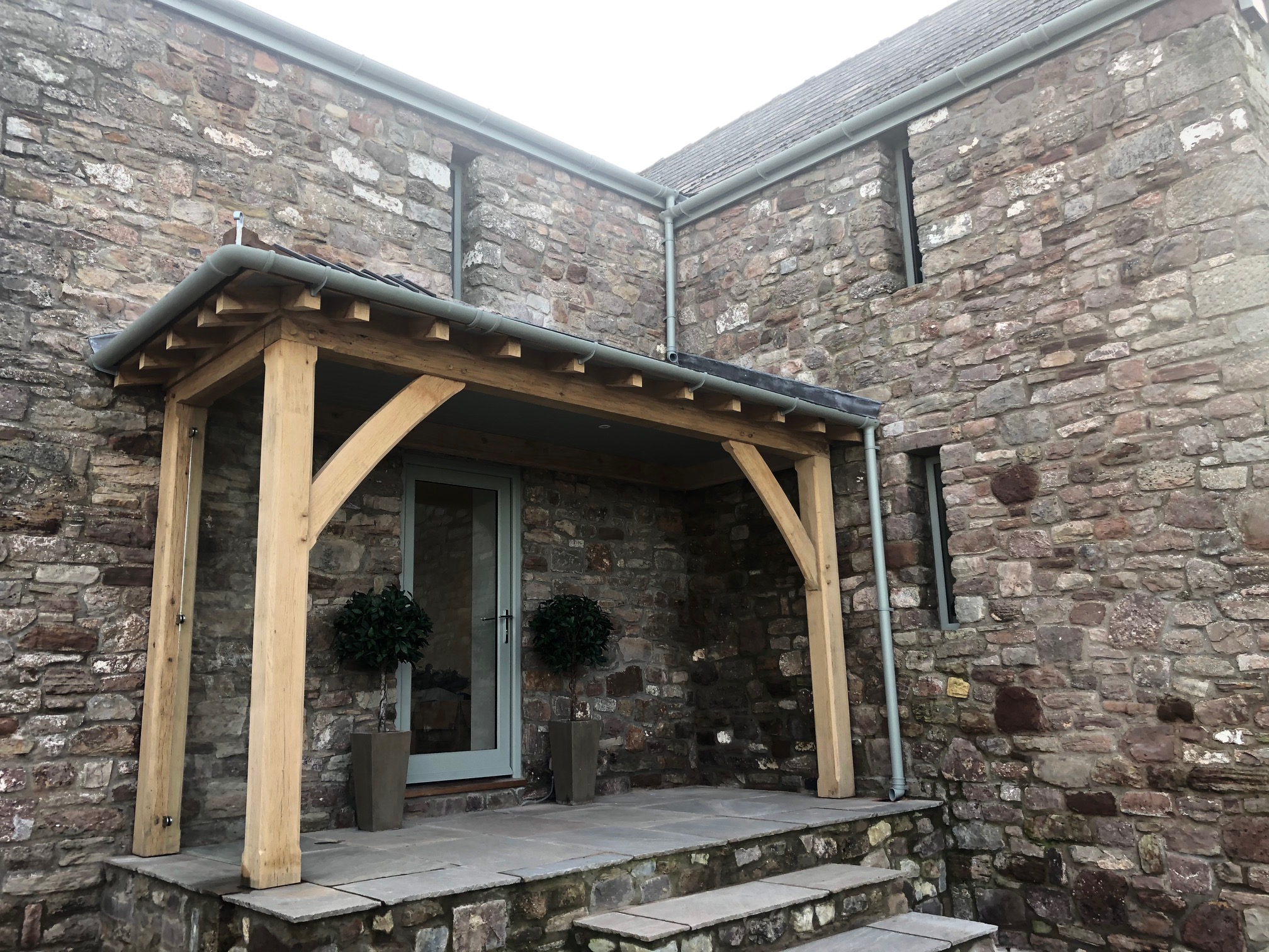 Oak framed lean too porch fitted onto a stone barn