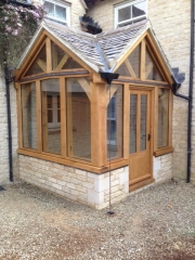 Corner oak framed porch with two gables