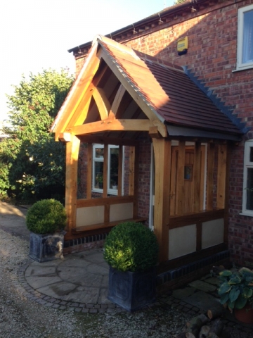 Oak porch with shaped tie beam and render panels