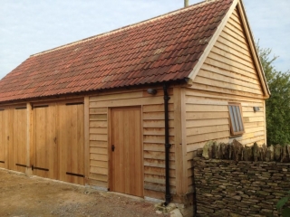 Triple bay oak garage enclosed with doors