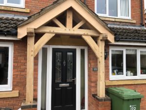 Oak porch fited to modern red brick house
