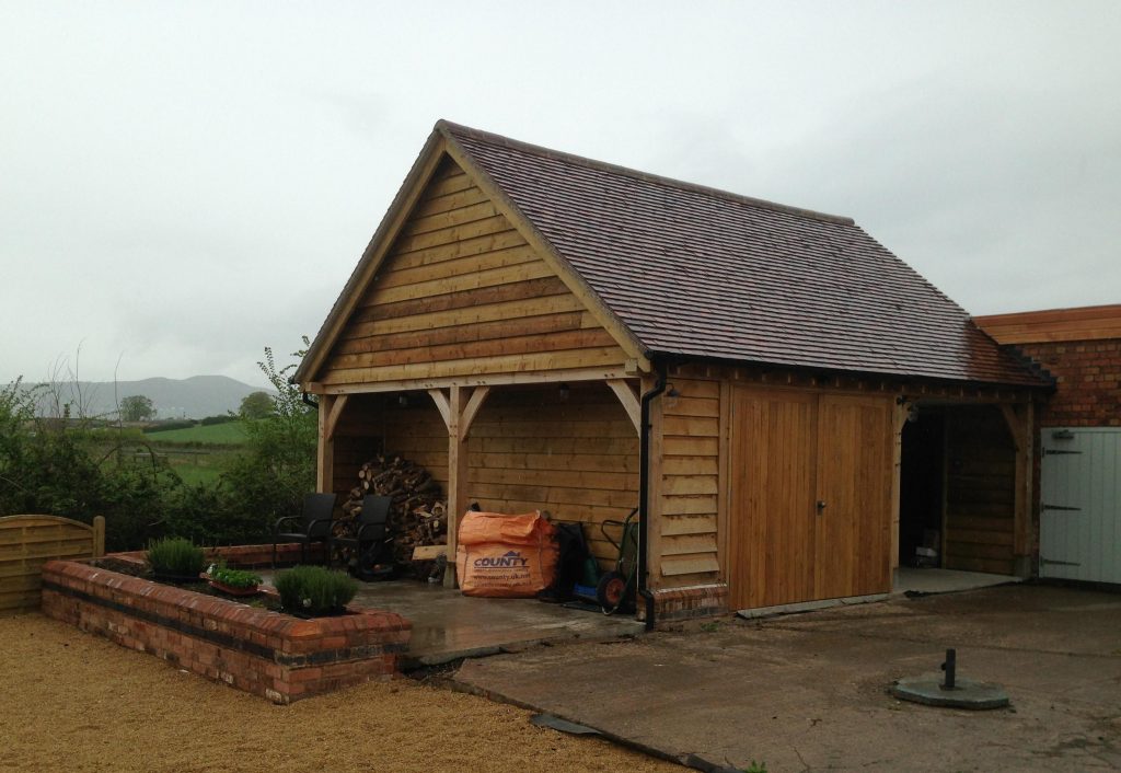Two bay oak garage with log store