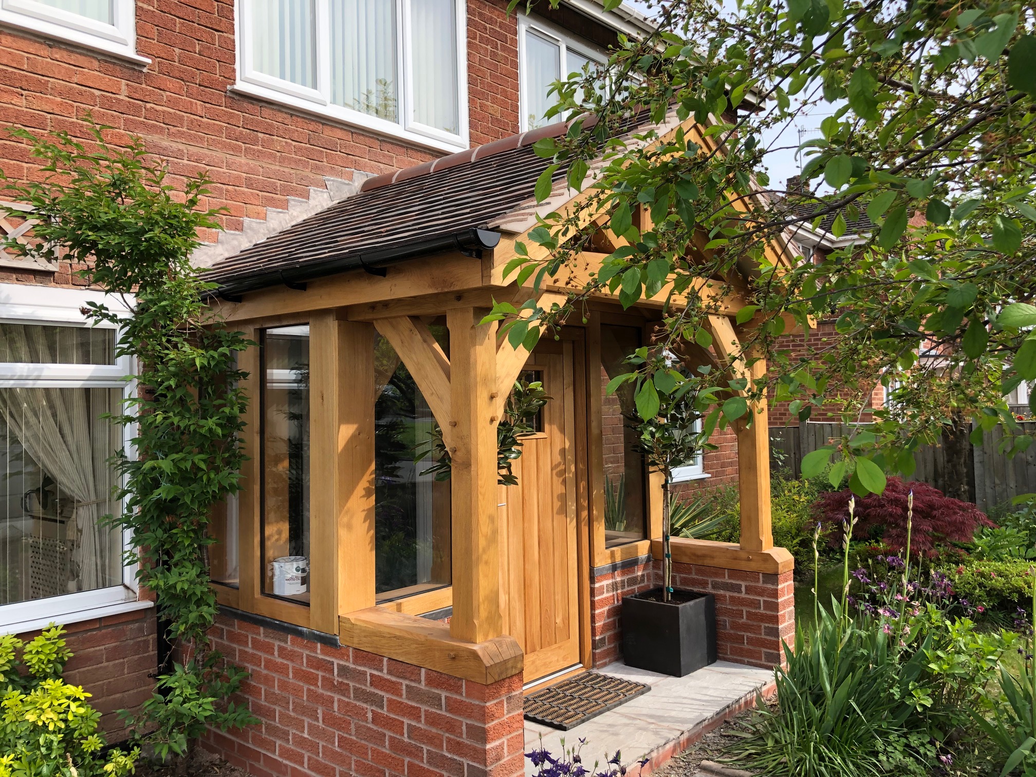 An enclosed oak framed porch with tiled roof