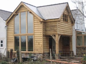 Two storey oak glass and clad extension frame