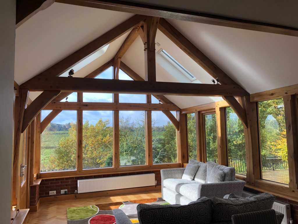 Internal view of oak framed garden room extension with king post truss