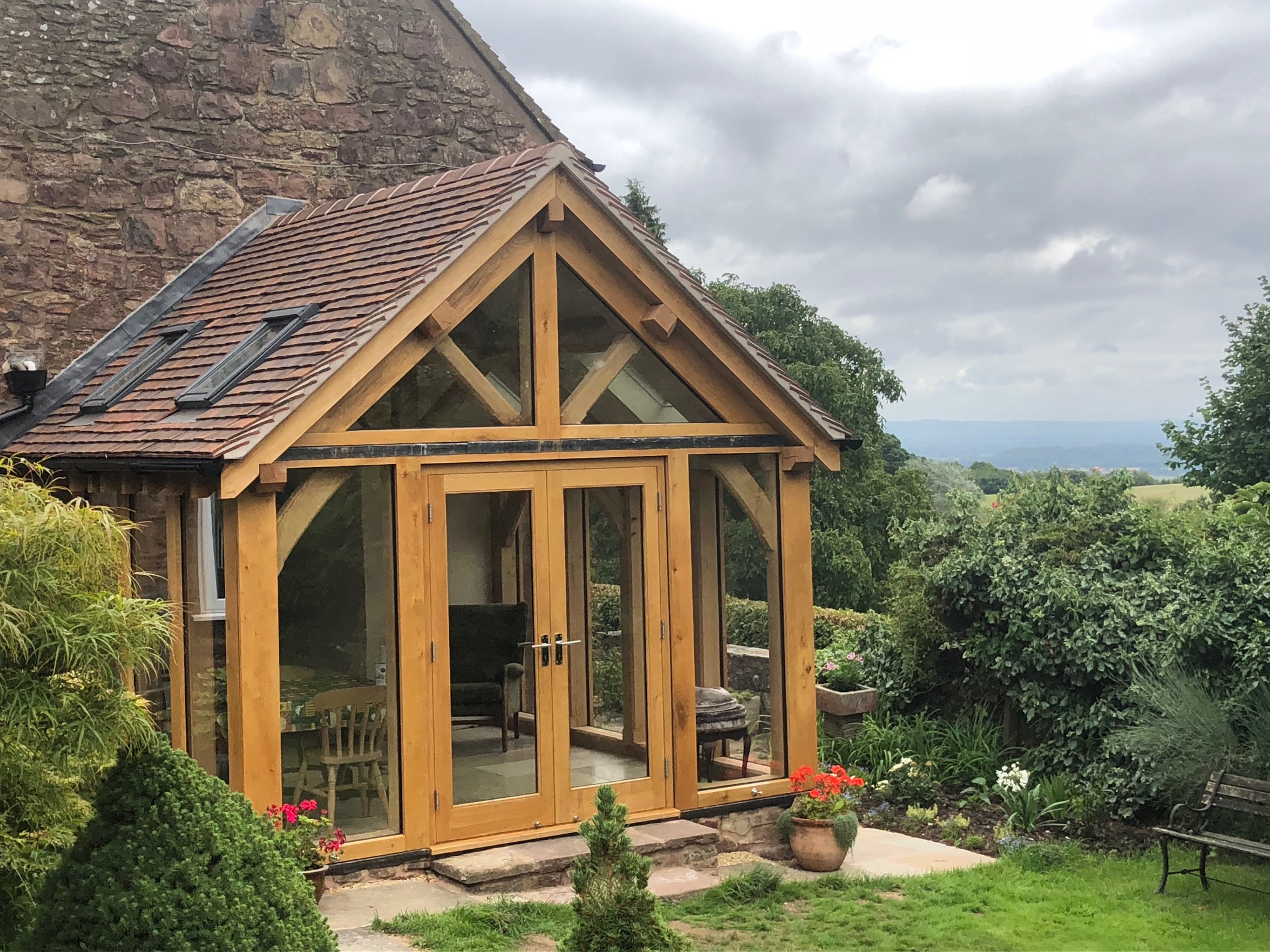 Oak framed conservatory with glass floor to ceiling