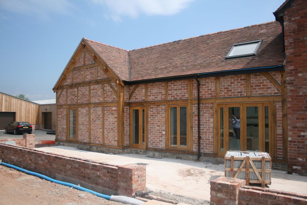 Oak framed extension with brick panels