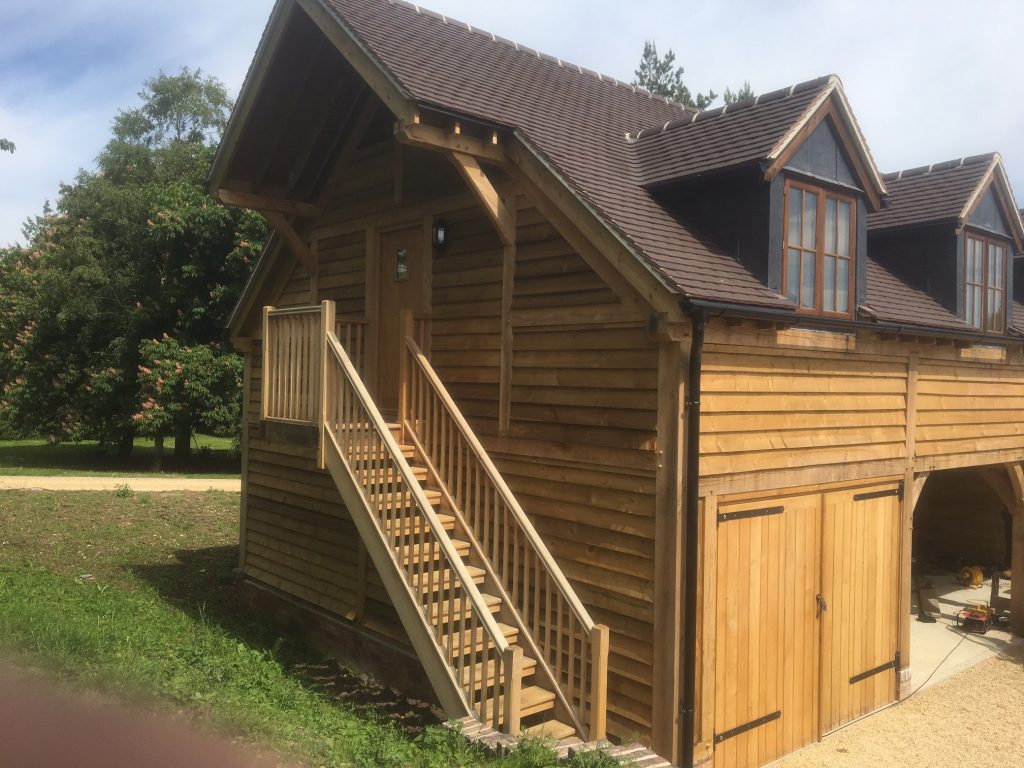 Two storey oak framed garage with two bays enclosed