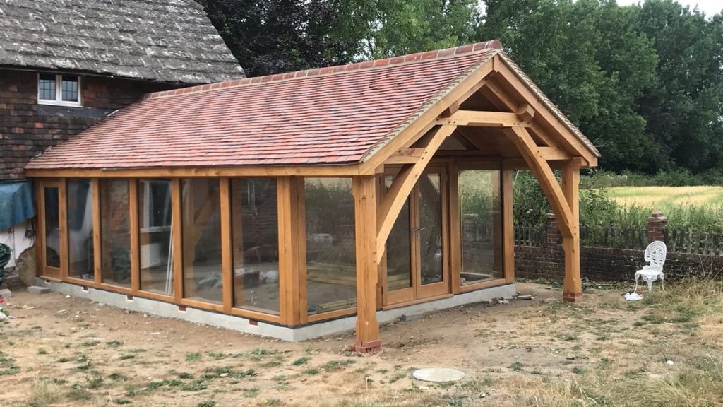 Oak extension frame with overhang covered area