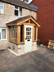 Oak framed porch with painted door.