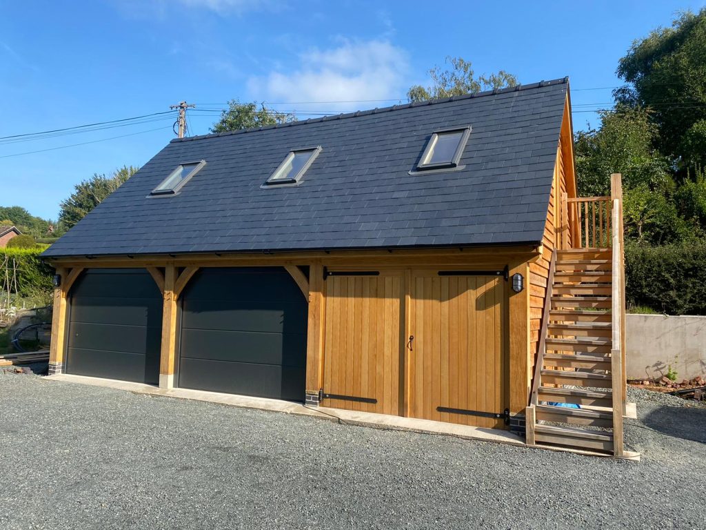 Triple bay oak frame garage with office above. All bays are enclosed with garage doors